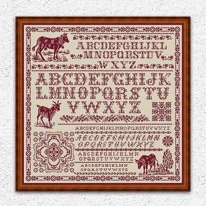 May include: A framed cross-stitch sampler with a cream background and burgundy details. The design features the alphabet, decorative borders, and animal illustrations. The text "INSTANT DOWNLOAD PDF" is at the bottom.