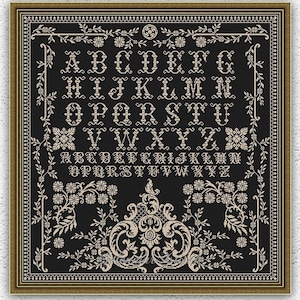 May include: A square cross-stitch pattern featuring an ornate alphabet in cream thread on a black background. The design includes uppercase and lowercase letters, intricate floral borders, and a central decorative motif, all enclosed in a gold frame.
