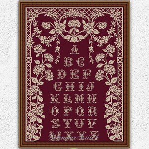 May include: A framed cross-stitch sampler with a burgundy background. The design features an alphabet in a decorative font, surrounded by floral motifs. The text "Selenmar Xstitch" and "Instant Download PDF" are also visible.