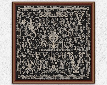 May include: Black and white cross stitch pattern featuring a vintage alphabet with ornate floral designs. The pattern is framed in a brown wood frame.