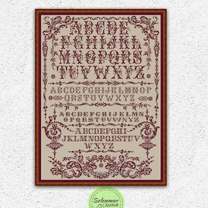 May include: A cross stitch pattern featuring a vintage alphabet with ornate flourishes in burgundy on a beige background. The pattern includes the letters A through Z in multiple styles. The pattern is framed in a brown wood frame. The text "INSTANT DOWNLOAD PDF" is at the bottom of the image.