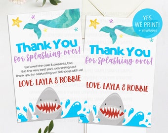 May include: Thank you cards with a mermaid and shark design. The cards are white with blue and purple accents. The text on the cards reads "Thank You for Splashing Over!" and "Love, Layla & Robbie".