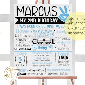 May include: A blue and gray birthday sign for a 2-year-old boy named Marcus. The sign says "Marcus, My 2nd Birthday" and includes details like his birthdate, weight, height, favorite things, and what he can do.