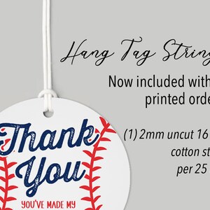May include: Round white thank you tag with a red and white baseball design. The tag says "Thank You" in blue text and "You've Made My Day" in smaller black text. The tag is attached to a white string.