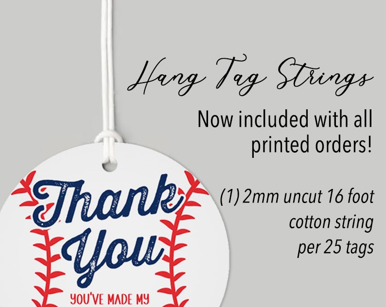 May include: Round white thank you tag with a red and white baseball design. The tag says "Thank You" in blue text and "You've Made My Day" in smaller black text. The tag is attached to a white string.