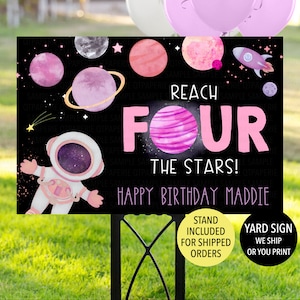 May include: A black and white yard sign with a pink and purple space theme. It says "Reach Four The Stars!" and "Happy Birthday Maddie".