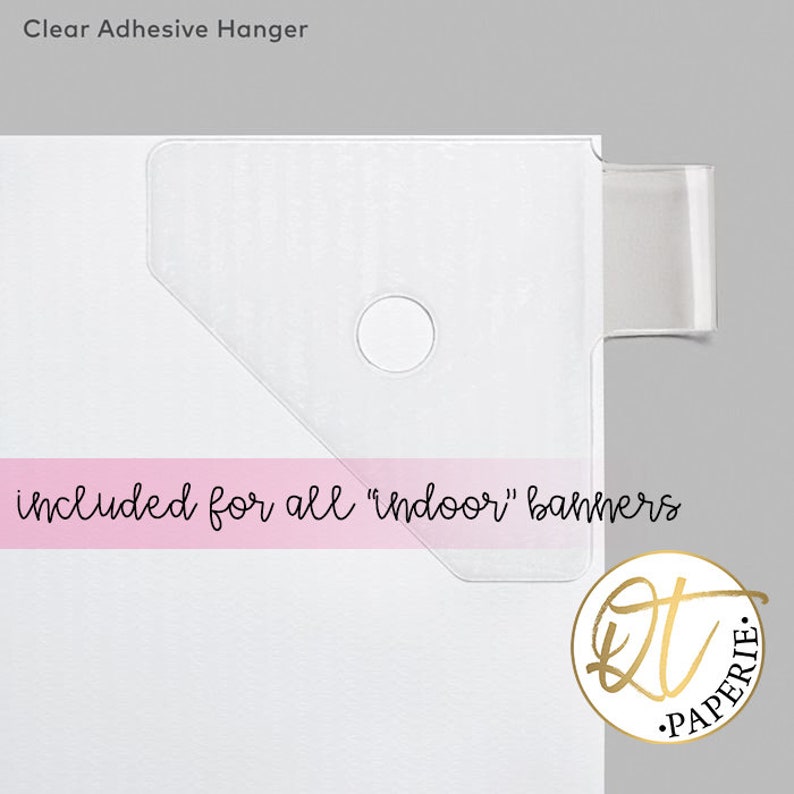 May include: Clear adhesive hanger for indoor banners. The hanger is made of clear plastic and has a hole in the center. The text "included for all "indoor" banners" is printed on a pink background.