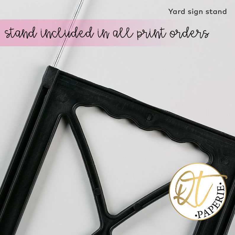May include: Black plastic yard sign stand with a wavy edge. The stand is designed to hold a printed sign. The text "stand included in all print orders" is visible at the top of the image.  Yard sign stand.