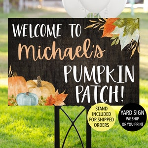 May include: A black and white yard sign with a rustic wood background. The sign says "Welcome to Michael's Pumpkin Patch!" with a fall-themed illustration of pumpkins and leaves. The sign includes the text "Stand Included for Shipped Orders" and "Yard Sign We Ship or You Print".