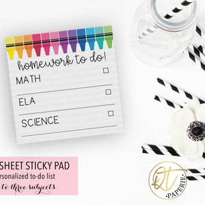 May include: A 50-sheet sticky note pad with a rainbow of crayons at the top. The pad has three lines for writing "homework to do!" with checkboxes next to each line. The lines are labelled "MATH", "ELA", and "SCIENCE".