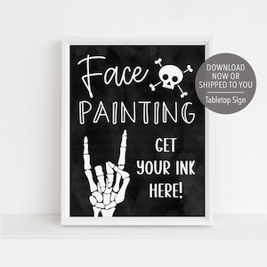May include: Black and white printable sign with a skull and crossbones, a skeleton hand, and the text "Face Painting Get Your Ink Here!"  Download now or shipped to you. Tabletop sign.
