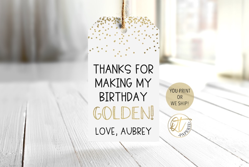 May include: White gift tag with gold confetti and the text "Thanks for making my birthday golden! Love, Aubrey".