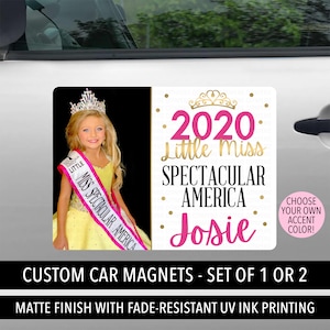 May include: A custom car magnet featuring a photo of a young girl wearing a yellow dress and a pink sash that says "Miss Spectacular America". The magnet also includes the text "2020 Little Miss Spectacular America Josie" in pink and gold lettering.