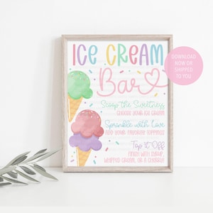 May include: A framed sign with the words "Ice Cream Bar" in pastel colours. Two ice cream cones are illustrated below the text. The sign includes instructions: "Scoop the Sweetness," "Choose your ice cream," "Sprinkle with Love," and "Top it Off."