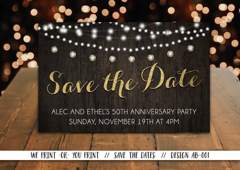 May include: Save the Date card with a rustic wood background and gold glitter text. The card features a string of white lights and the text "Save the Date", "Alec and Ethel's 50th Anniversary Party", "Sunday, November 19th at 4pm", and "We Print-Or-You Print // Save the Dates // Design AB-001".