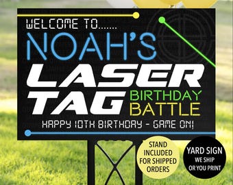 May include: Black and green laser tag birthday party yard sign with the text "Welcome to Noah's Laser Tag Birthday Battle Happy 10th Birthday - Game On!" and a green and yellow target graphic. The sign includes a stand.
