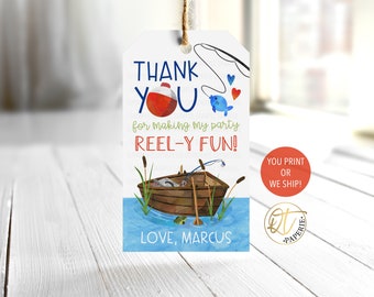 May include: Thank you tag with a fishing theme. It features a red and white bobber, a blue fish, a fishing rod, and a boat on a blue lake. The text reads "Thank you for making my party reel-y fun!" and "Love, Marcus".
