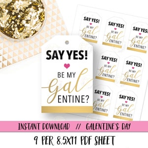 May include: Nine printable gift tags with a gold and white design. The tags feature the text "Say Yes! Be My Galentine?" with a pink heart. The tags are designed for Galentine's Day.