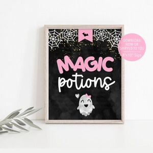 May include: A printable 8x10 inch sign with a black chalkboard background. The sign says "Magic potions" in pink letters with a cute ghost illustration. The sign is framed in a light wood frame.