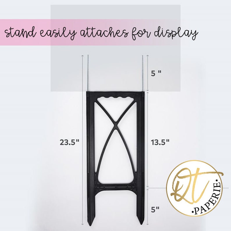 May include: Black metal stand with a 23.5 inch height, 13.5 inch width, and 5 inch depth. The stand has a decorative design and is used for displaying items.