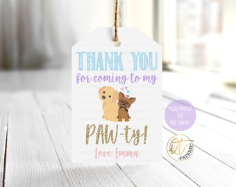 May include: Thank you for coming to my paw-ty!  A white tag with a purple border features a cartoon dog and a cartoon puppy with hearts above them. The text "Thank you for coming to my paw-ty! Love. Emma" is printed on the tag.
