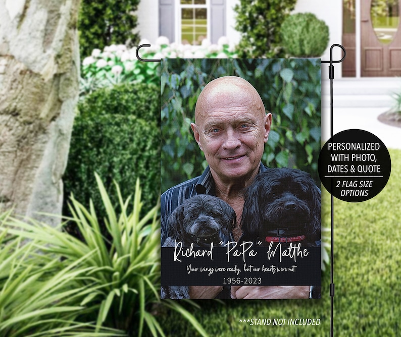 Pode incluir: Bandeira de jardim personalizada com foto de um homem e dois c&atilde;es pretos. A bandeira inclui o texto "Richard 'PaPa' Matthe", uma cita&ccedil;&atilde;o e datas. Projetada para uso externo.