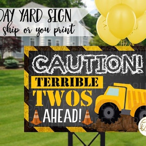 May include: A yellow and black construction-themed birthday yard sign with the text "CAUTION! TERRIBLE TWOS AHEAD!" and a cartoon yellow dumper truck.