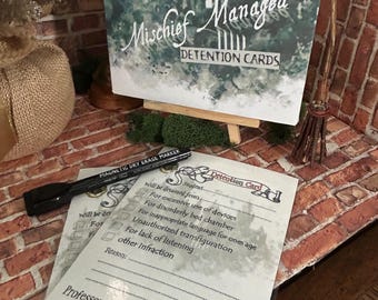 Könnte beinhalten: Ein Satz weißer Strafkarten mit einem schwarzen Trockenlöschmarker. Die Karten zeigen eine Illustration von Hogwarts und den Text "Mischief Managed Detention Cards". Die Karten haben Kontrollkästchen für verschiedene Vergehen, darunter "Übermäßiger Gebrauch von Geräten", "Unordentliches Schlafzimmer" und "Unangemessene Sprache".