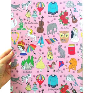 May include: A pink background with a repeating pattern of illustrations and letters of the alphabet. Each letter is paired with an image and a phrase that starts with that letter. For example, "T is for Tent" is paired with an image of a tent.