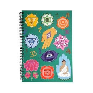 May include: A green spiral bound notebook featuring colourful illustrations of chakras, hands, and flowers. The notebook includes the Sanskrit word "Om" and other symbols.