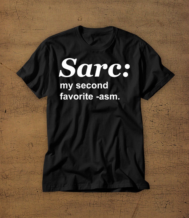 May include: Black t-shirt with white text that reads "Sarc: my second favourite -asm."