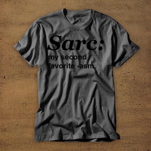 May include: A dark grey t-shirt with the text "Sarc: my second favourite -asm." printed in black.