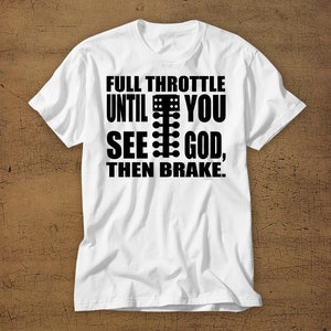 May include: White t-shirt with black text that reads "Full Throttle Until You See God, Then Brake."  The text includes a graphic of a drag racing Christmas tree.