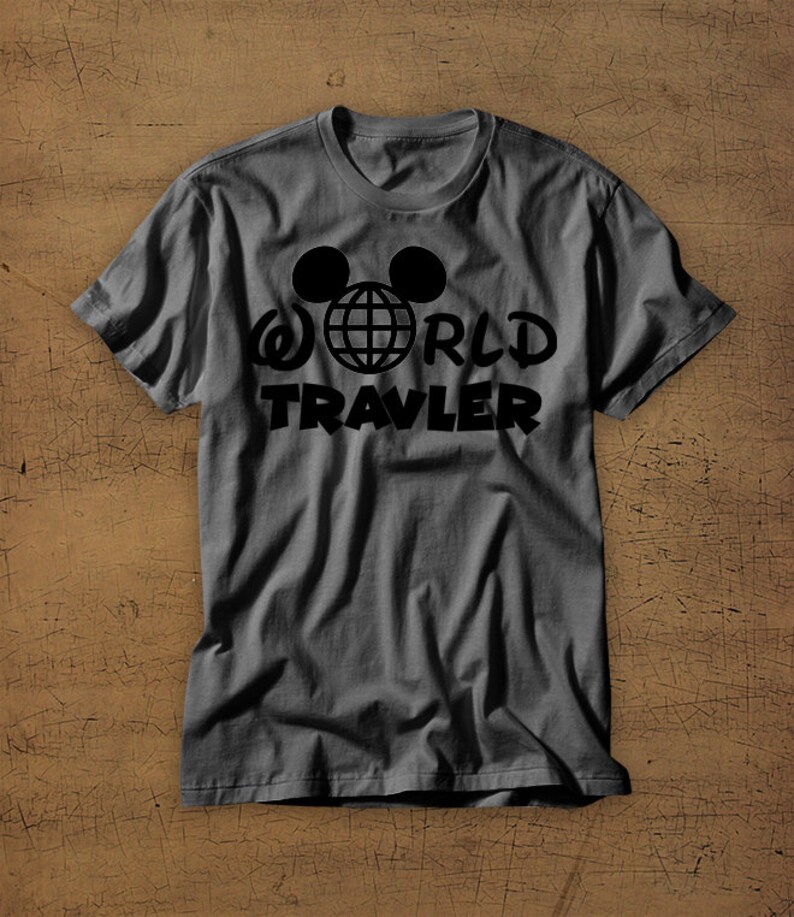 May include: A gray t-shirt with a black graphic of Mickey Mouse ears with a globe inside and the text "WORLD TRAVELER" underneath.