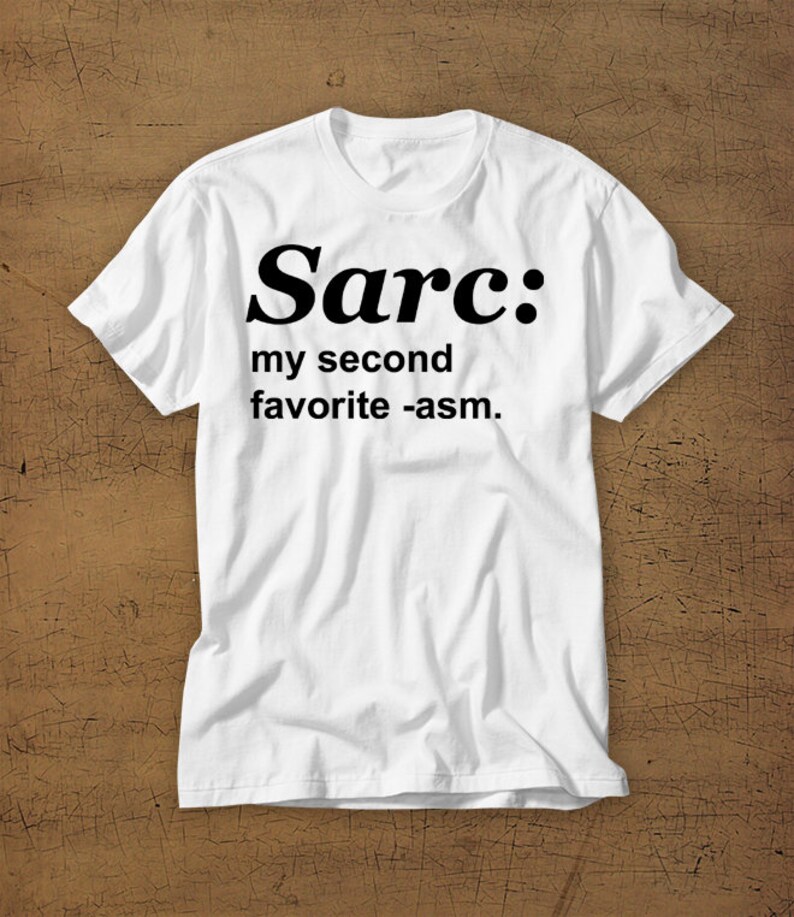 May include: White t-shirt with black text that reads "Sarc: my second favourite -asm."