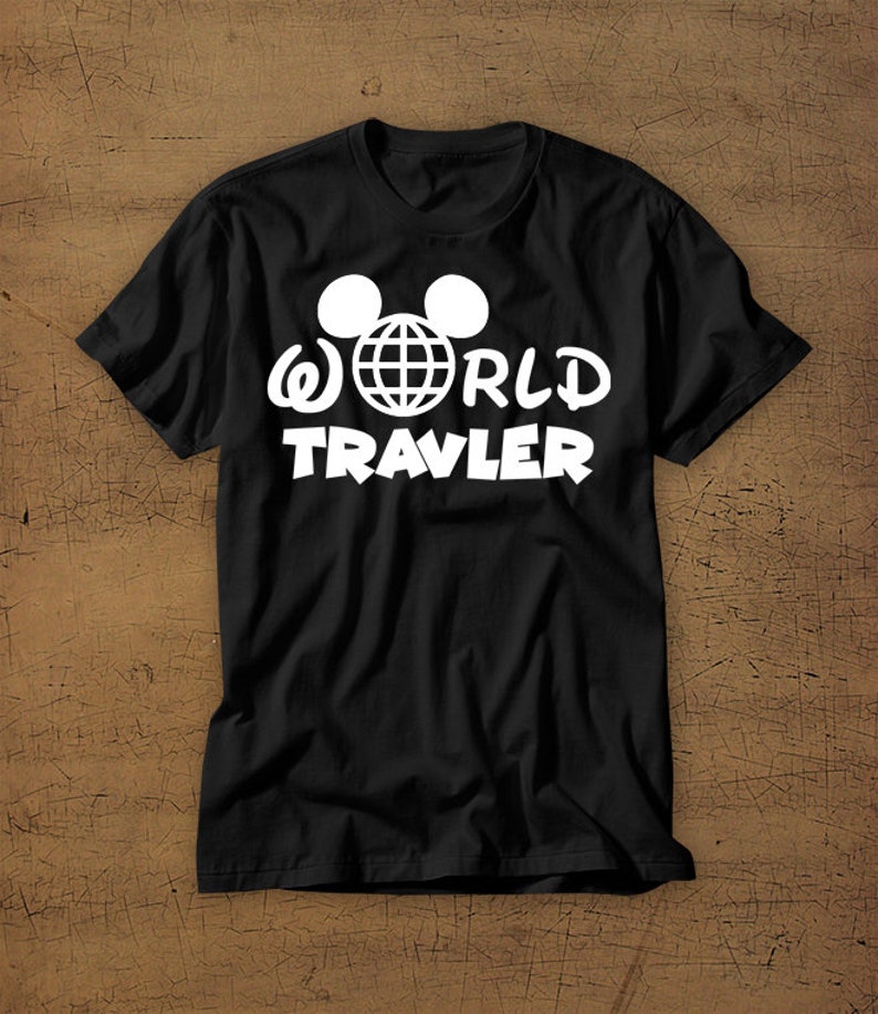 May include: Black t-shirt with a white graphic of Mickey Mouse ears with a globe inside and the text "WORLD TRAVLER"