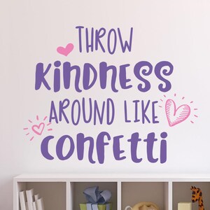 May include: Purple wall decal with the text "Throw kindness around like confetti" with pink hearts and sparkles.