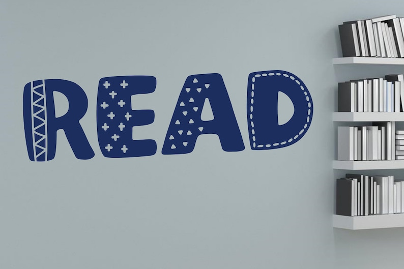 May include: A blue wall decal spelling out the word "READ" in a playful, stylized font. Each letter has a different pattern, including geometric shapes, plus signs, and a stitched border.