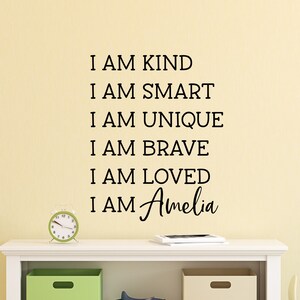 May include: A wall decal with the text "I am kind, I am smart, I am unique, I am brave, I am loved, I am Amelia".