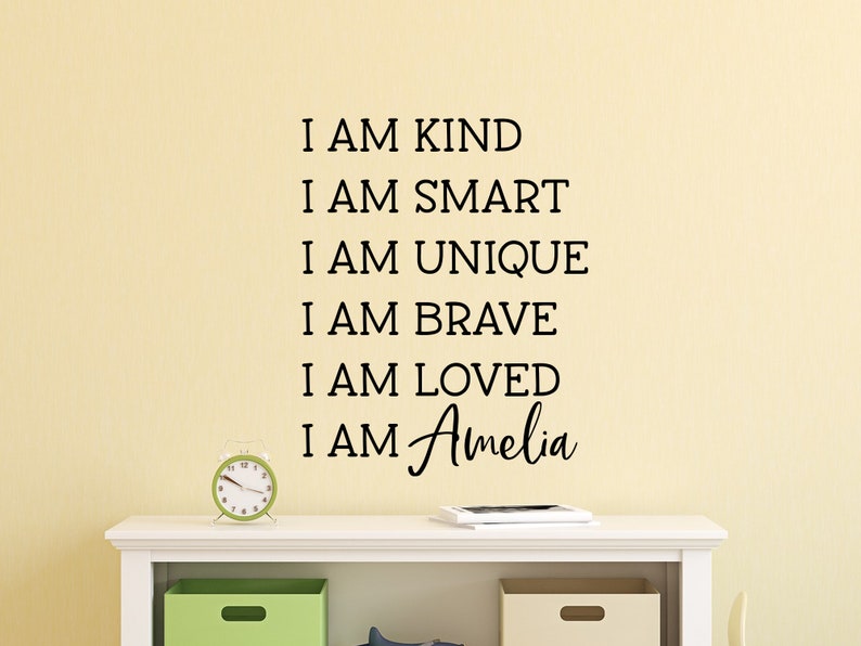 May include: A wall decal with the text "I am kind, I am smart, I am unique, I am brave, I am loved, I am Amelia".