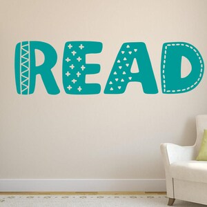 May include: Teal blue wall decal with the word "READ" in a whimsical font. Each letter has a different pattern, including triangles, plus signs, and zigzags.