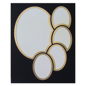 May include: A black picture frame with five gold-rimmed openings for photos. The openings are arranged in a cascading pattern, with the largest opening at the top and the smallest opening at the bottom.