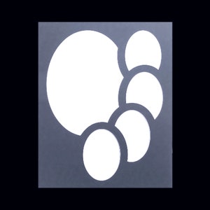 May include: A gray background with five white circles cut out in a cascading pattern. The circles are different sizes and overlap each other.