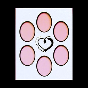 May include: White card with six pink circles arranged in a circle around a black and white heart design.