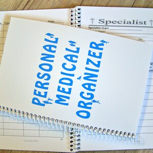 May include: A white spiral bound notebook with blue text that reads "Personal Medical Organizer". The notebook has a section for "Specialist" information.