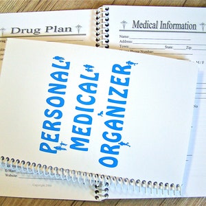 May include: A white spiral bound notebook with the words "Personal Medical Organizer" printed in blue. The notebook has a section labeled "Drug Plan" and another section labeled "Medical Information".