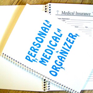 May include: A white spiral bound notebook with the words "PERSONAL MEDICAL ORGANIZER" in blue text. The notebook has a section for medical insurance information.
