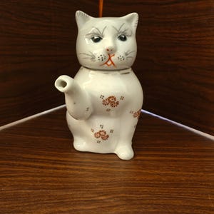 Single cup vintage cat porcelain teapot.