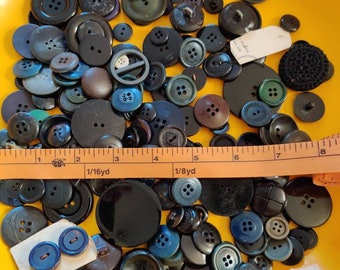 Assorted buttons, black and ebony colored, small , medium to large sized. Over 100 buttons.