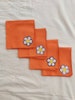 Cocktail napkins with floral embroidered accents, orange colorway, set of four 